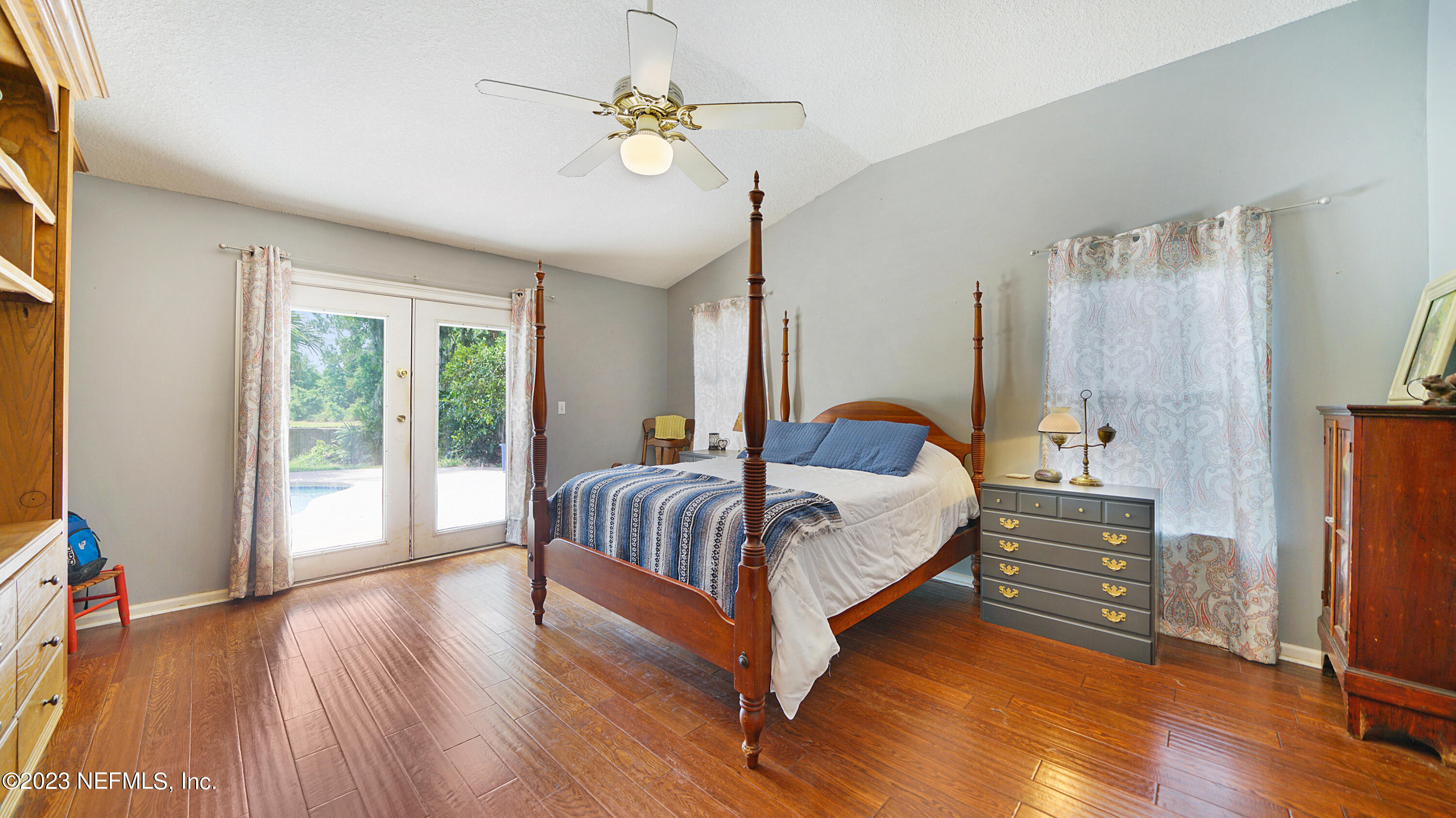 644 Hummingbird Court St. Johns, FL 32259 - Photo 7 of 36 a spacious bedroom with a bed and a chandelier