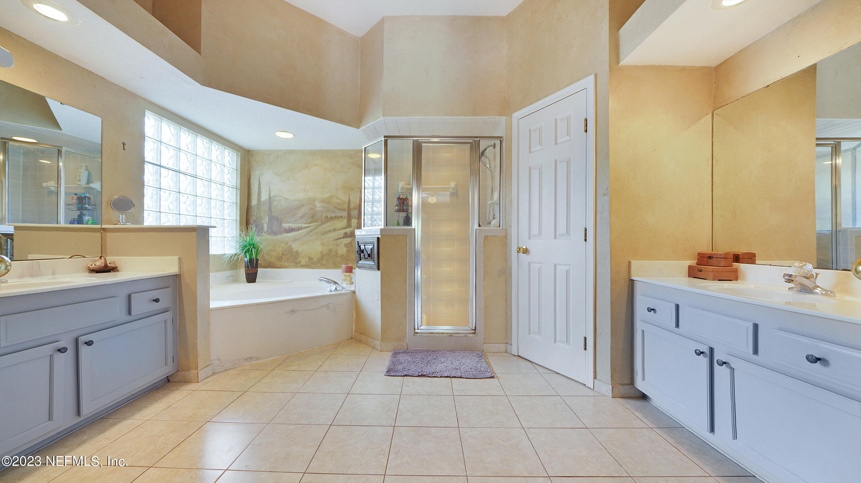 644 Hummingbird Court St. Johns, FL 32259 - Photo 8 of 36 a spacious bathroom with a double vanity sink a mirror and a bathtub