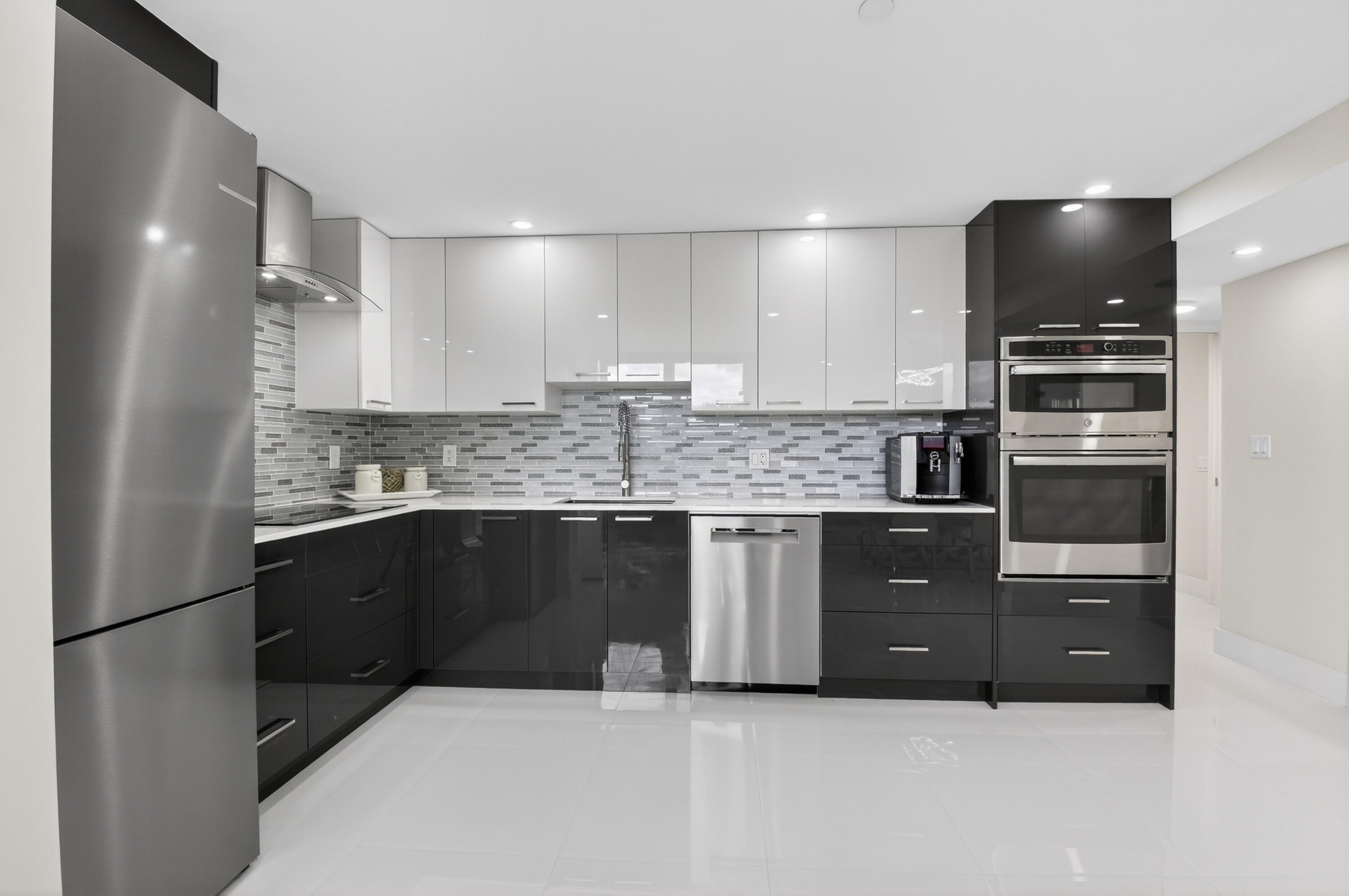 a kitchen with stainless steel appliances a refrigerator sink and microwave
