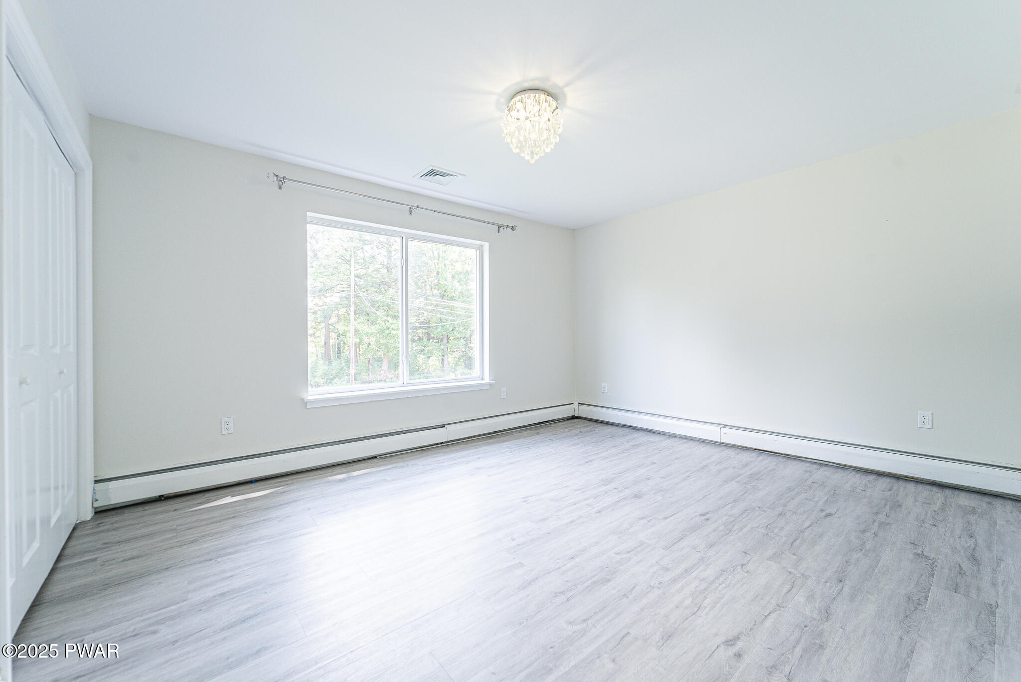153 Hatton Road Hawley, PA 18428 - Photo 20 of 38 an empty room with wooden floor and windows