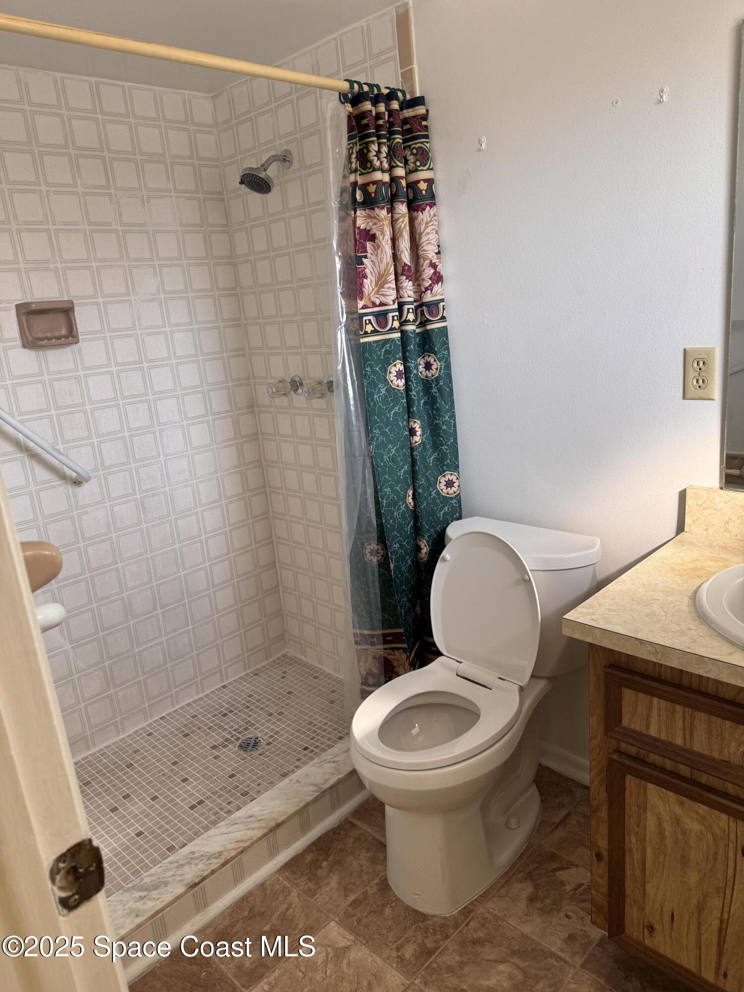 642 Altura Drive Cocoa, FL 32927 - Photo 11 of 13 a white toilet sitting next to a bath tub shower