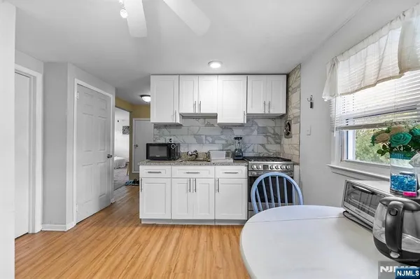 a kitchen with a white stove top oven and sink