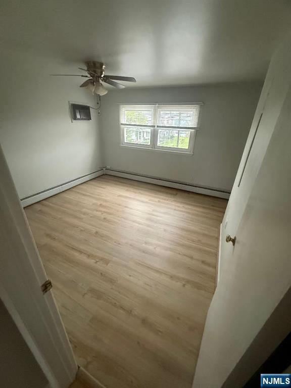 119 Garibaldi Avenue, Unit 2 Lodi, NJ 07644 - Photo 7 of 8 en empty room with windows and ceiling fan