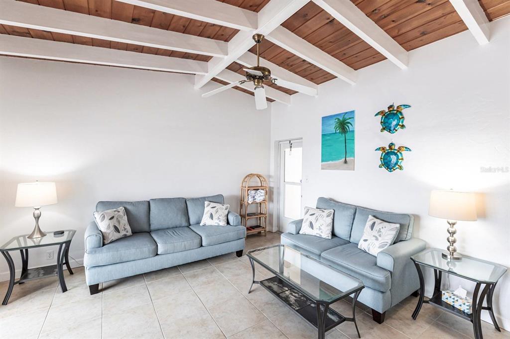 6006 Midnight Pass Road, Unit 5 Sarasota, FL 34242 - Photo 3 of 22 a living room with furniture and a ceiling fan