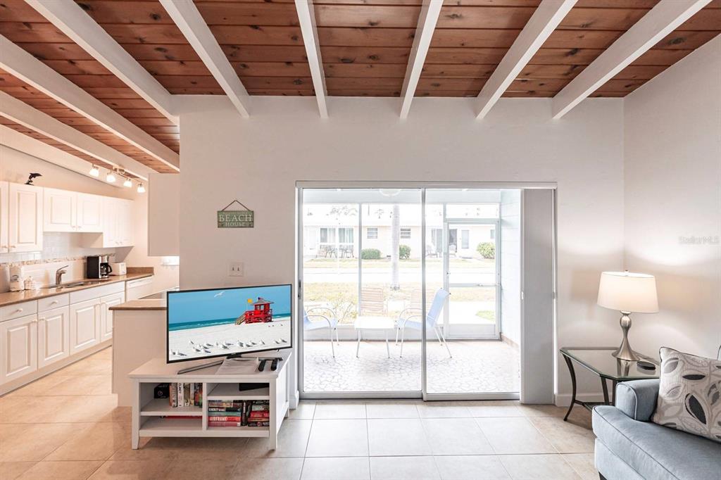 6006 Midnight Pass Road, Unit 5 Sarasota, FL 34242 - Photo 4 of 22 a living room with furniture and a flat screen tv