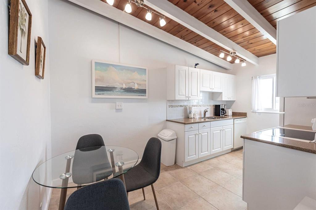 6006 Midnight Pass Road, Unit 5 Sarasota, FL 34242 - Photo 7 of 22 a kitchen with stainless steel appliances granite countertop a sink and a refrigerator