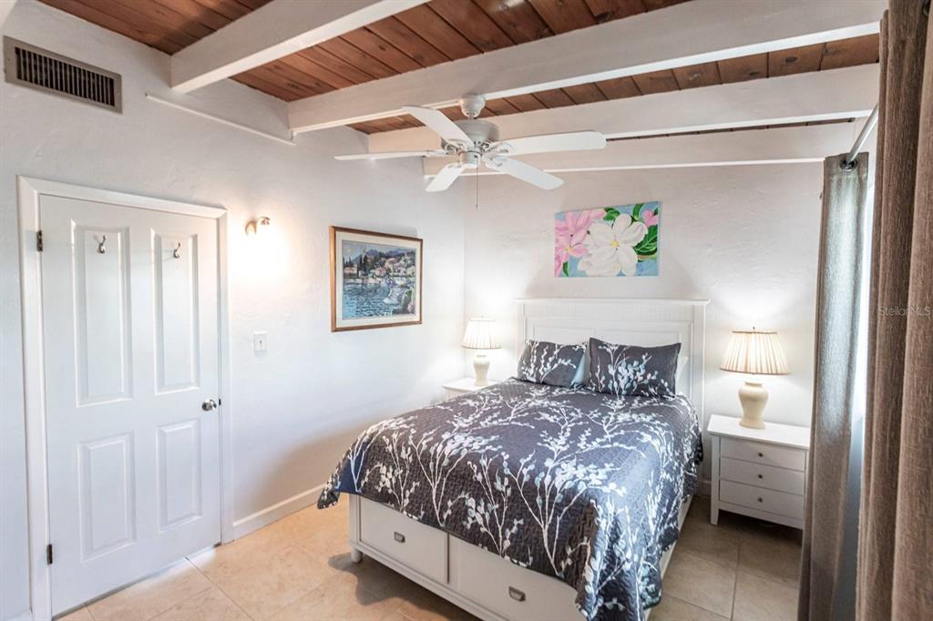 6006 Midnight Pass Road, Unit 5 Sarasota, FL 34242 - Photo 10 of 22 a bedroom with a bed and a window