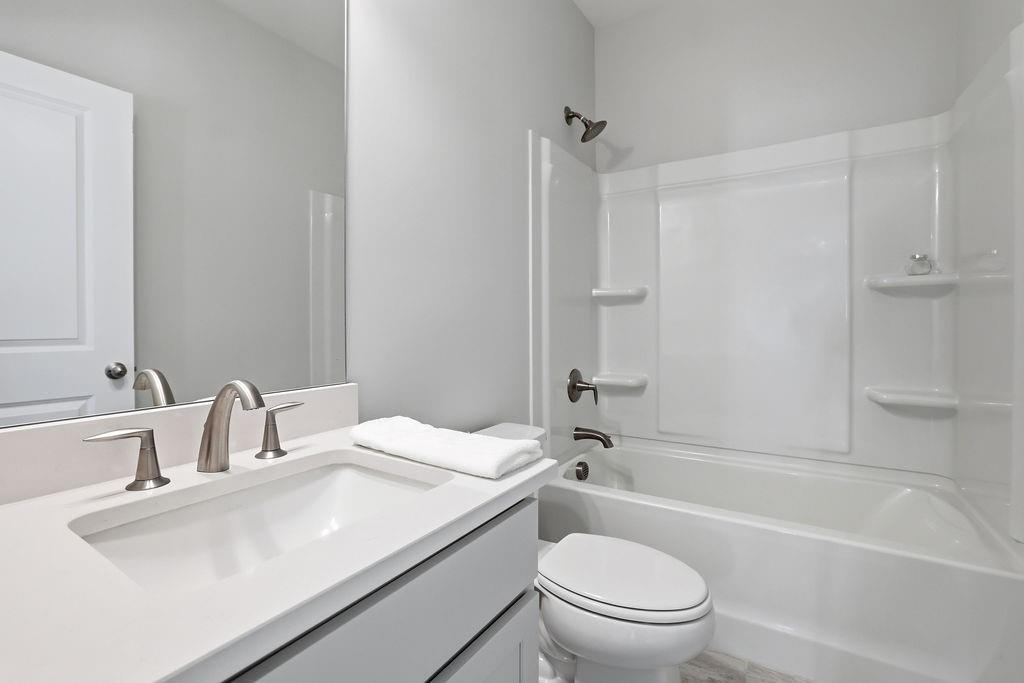 2865 Ferncliff Street Cumming, GA 30028 - Photo 29 of 41 a bathroom with a sink a toilet and a bathtub