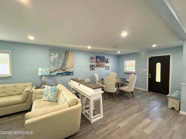 a living room with furniture and wooden floor