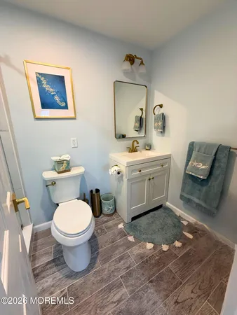 a spacious bathroom with a toilet sink and mirror