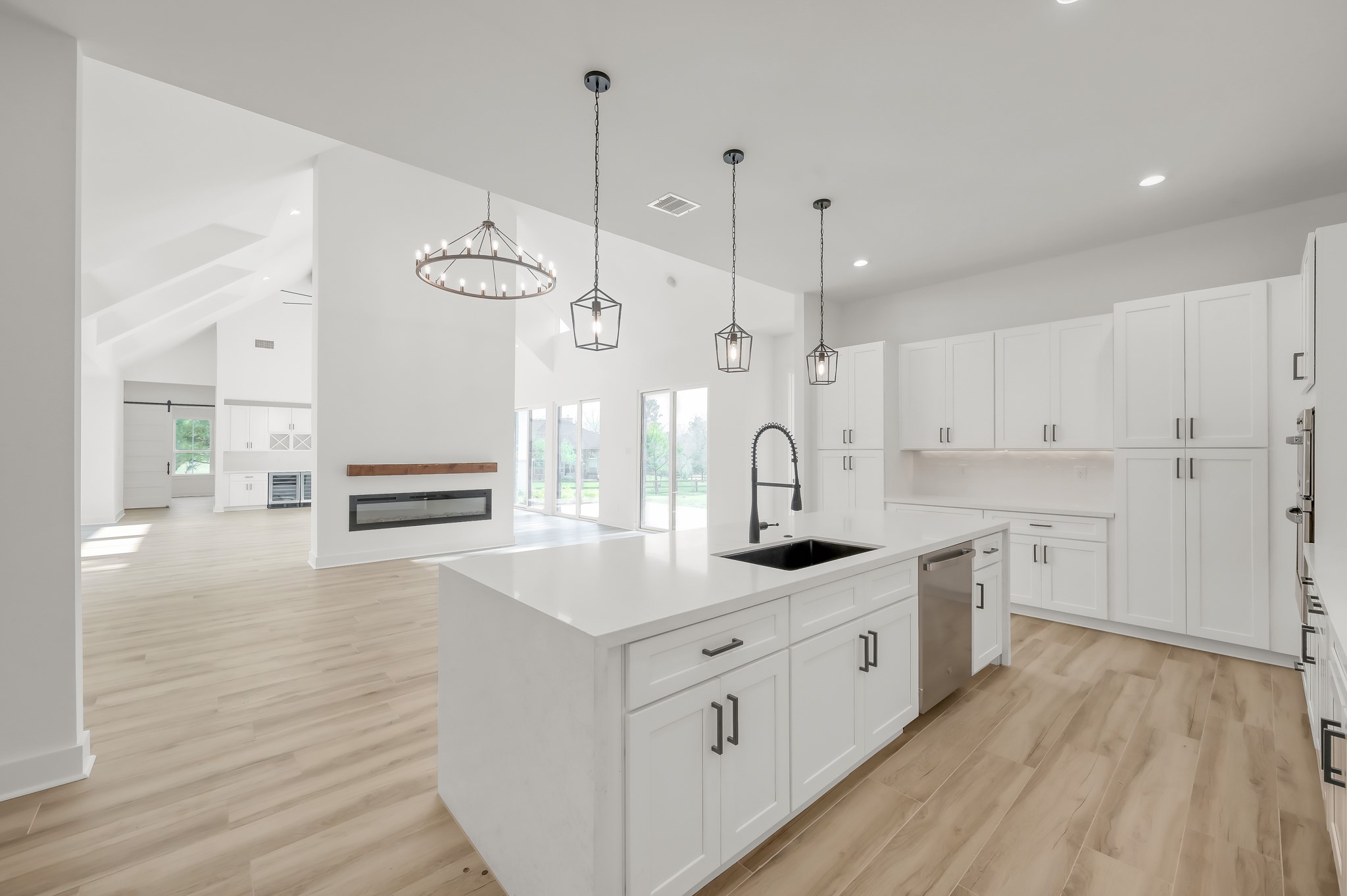 14742 Turquoise Trail Willis, TX 77378 - Photo 20 of 48 Kitchen perspective highlighting the seamless flow between cooking, dining, and living areas—perfect for entertaining and modern living.