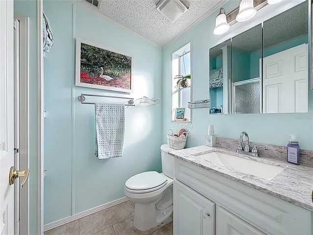 a white toilet sitting next to a bathroom sink