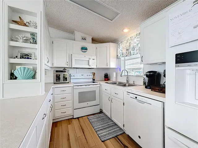 a kitchen with stainless steel appliances a refrigerator sink and cabinets