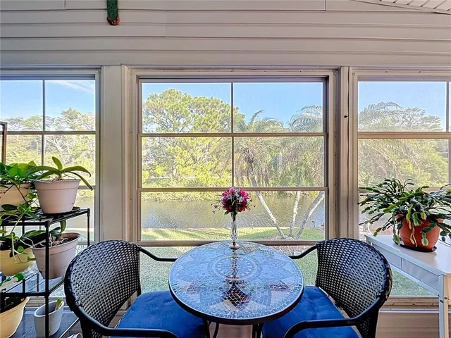 a living room with lots of furniture and a large window