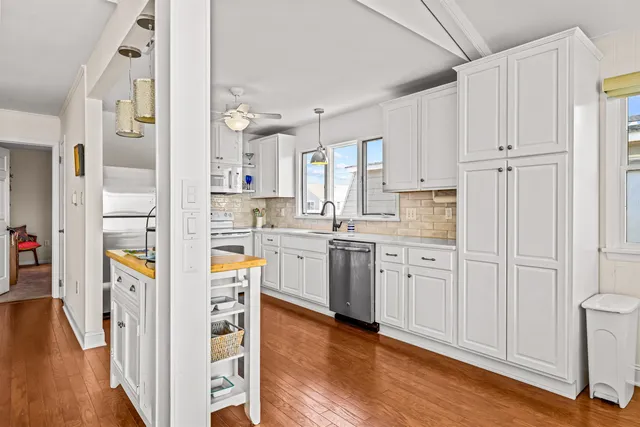 a kitchen with stainless steel appliances granite countertop a sink and cabinets