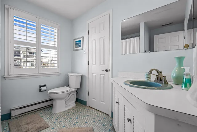 a bathroom with a tub a sink a window and a shower