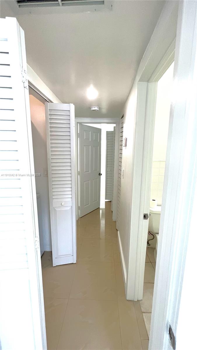 8235 Crespi Boulevard, Unit 1 Miami Beach, FL 33141 - Photo 13 of 24 a view of a room with a white door