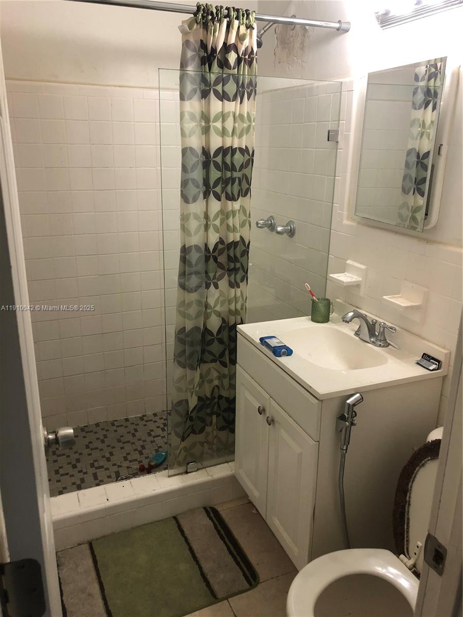 8235 Crespi Boulevard, Unit 1 Miami Beach, FL 33141 - Photo 16 of 24 a bathroom with a sink and a shower
