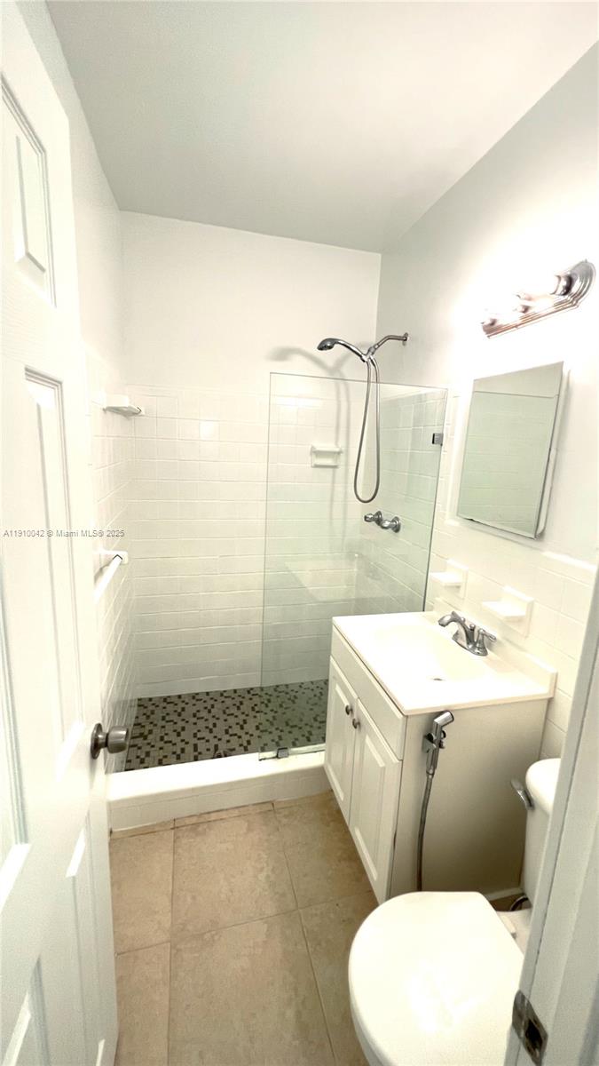8235 Crespi Boulevard, Unit 1 Miami Beach, FL 33141 - Photo 17 of 24 a bathroom with a sink a toilet and shower