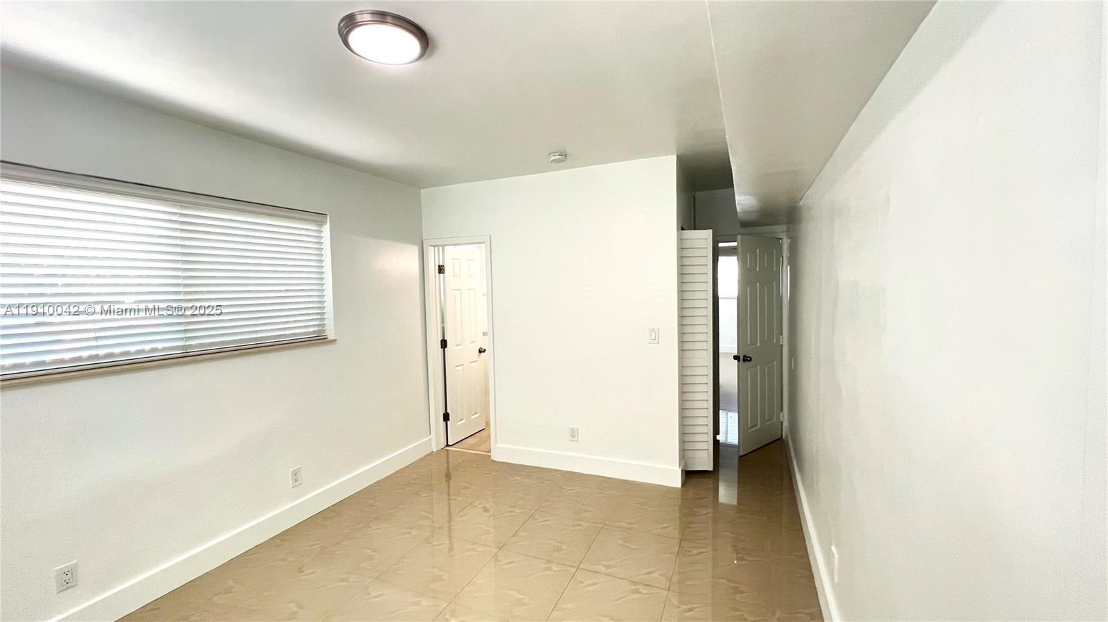8235 Crespi Boulevard, Unit 1 Miami Beach, FL 33141 - Photo 18 of 24 a view of a room with an empty space