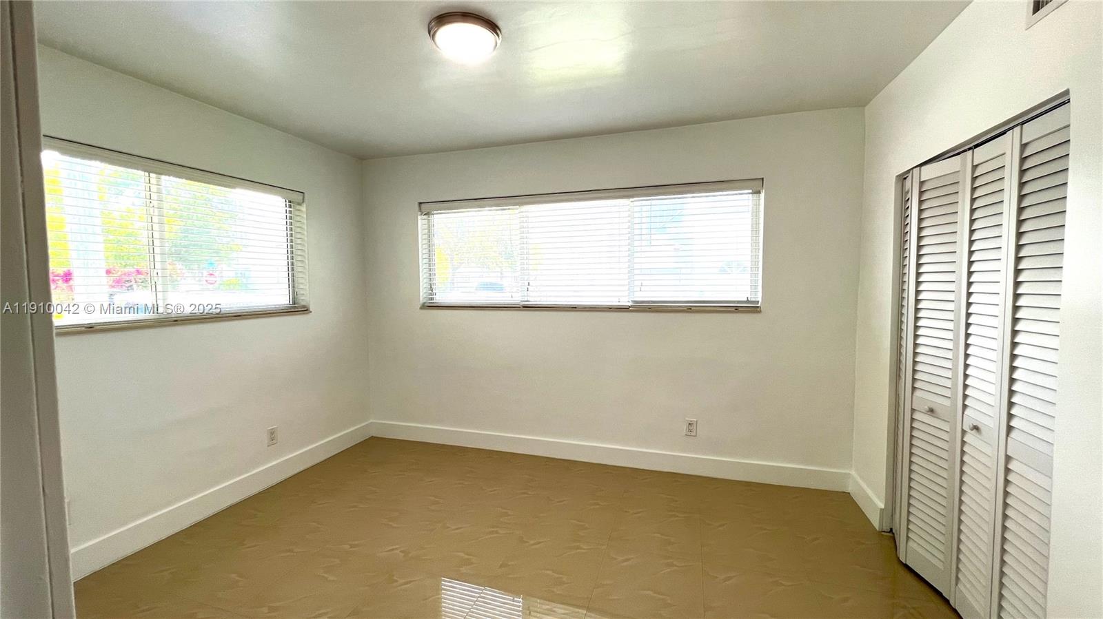 8235 Crespi Boulevard, Unit 1 Miami Beach, FL 33141 - Photo 7 of 24 an empty room with a window