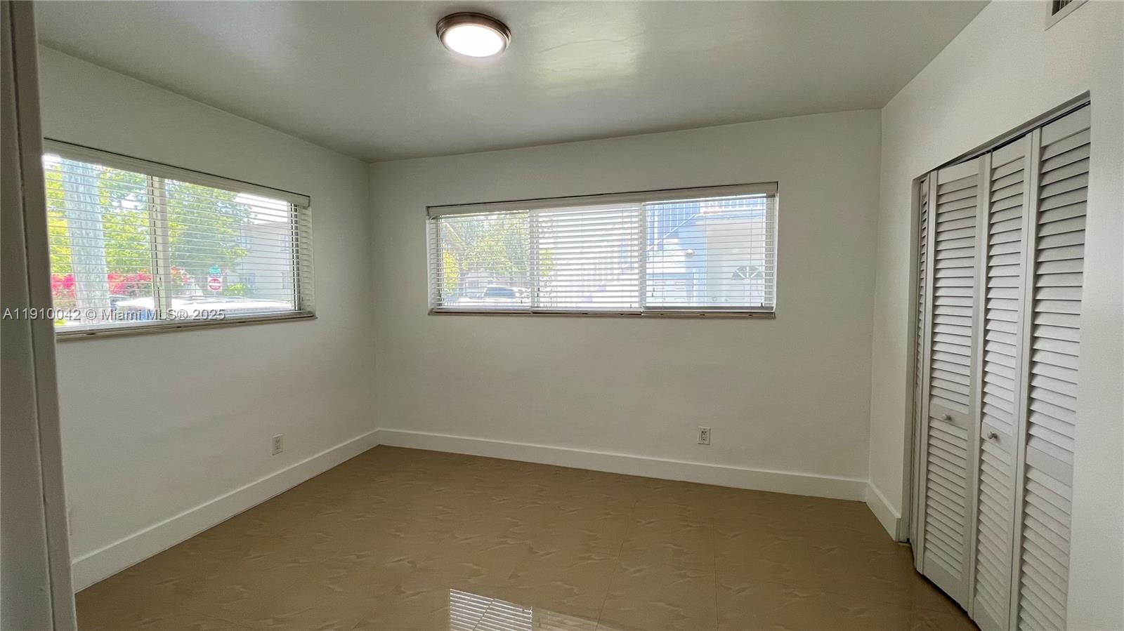 8235 Crespi Boulevard, Unit 1 Miami Beach, FL 33141 - Photo 9 of 24 an empty room with a window