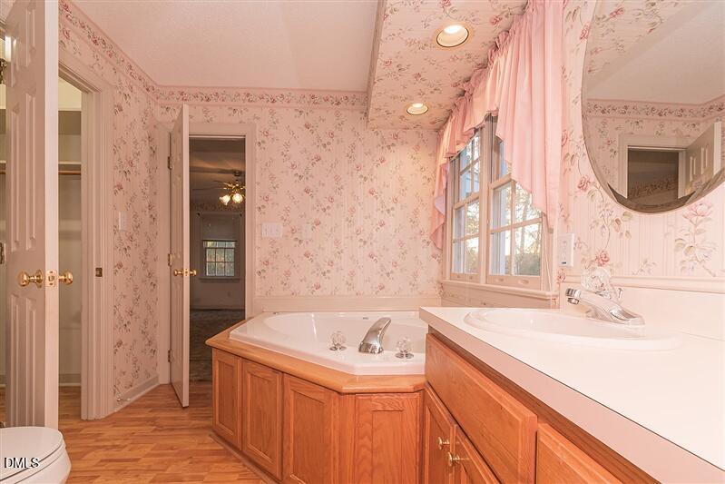 9908 Huntwyck Drive Raleigh, NC 27603 - Photo 12 of 32 a bathroom with a sink and a bathtub