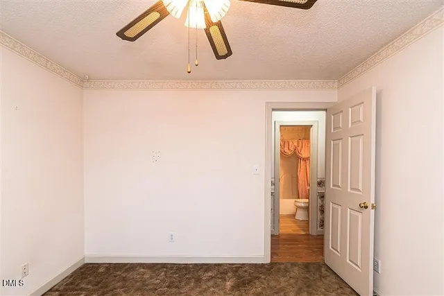 a view of hallway with chandelier fan and wooden floor