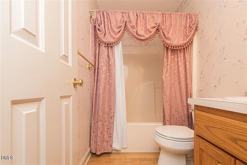 9908 Huntwyck Drive Raleigh, NC 27603 - Photo 22 of 32 a bathroom with a toilet and a shower