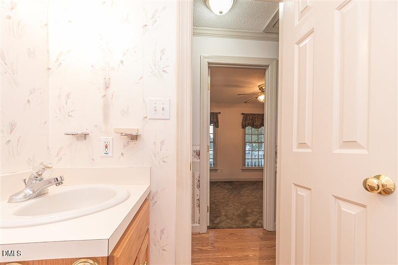 9908 Huntwyck Drive Raleigh, NC 27603 - Photo 23 of 32 a bathroom with a sink and a mirror