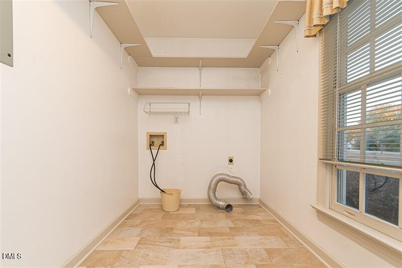 9908 Huntwyck Drive Raleigh, NC 27603 - Photo 24 of 32 a room that has a rug and a window in it