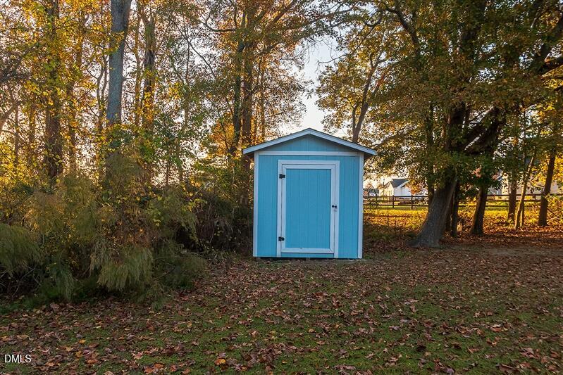 9908 Huntwyck Drive Raleigh, NC 27603 - Photo 31 of 32 a house with trees in front of it