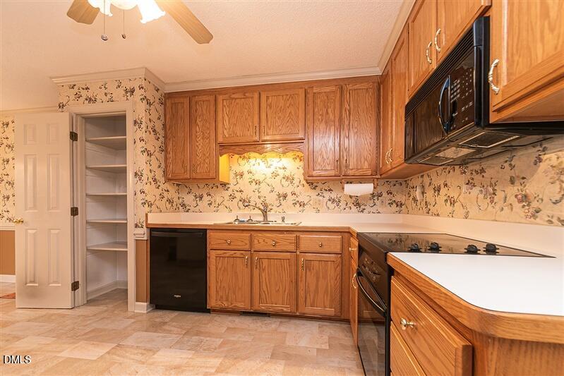 9908 Huntwyck Drive Raleigh, NC 27603 - Photo 3 of 32 a kitchen with stainless steel appliances granite countertop a sink and a stove