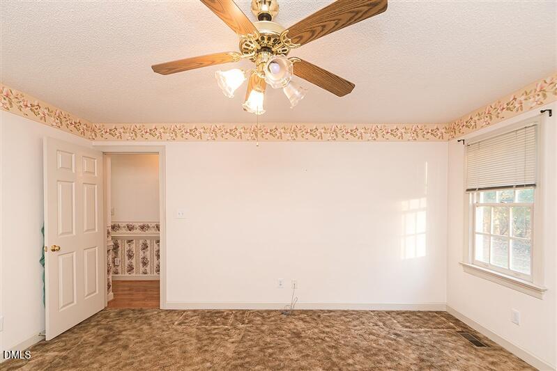 9908 Huntwyck Drive Raleigh, NC 27603 - Photo 9 of 32 a view of an empty room