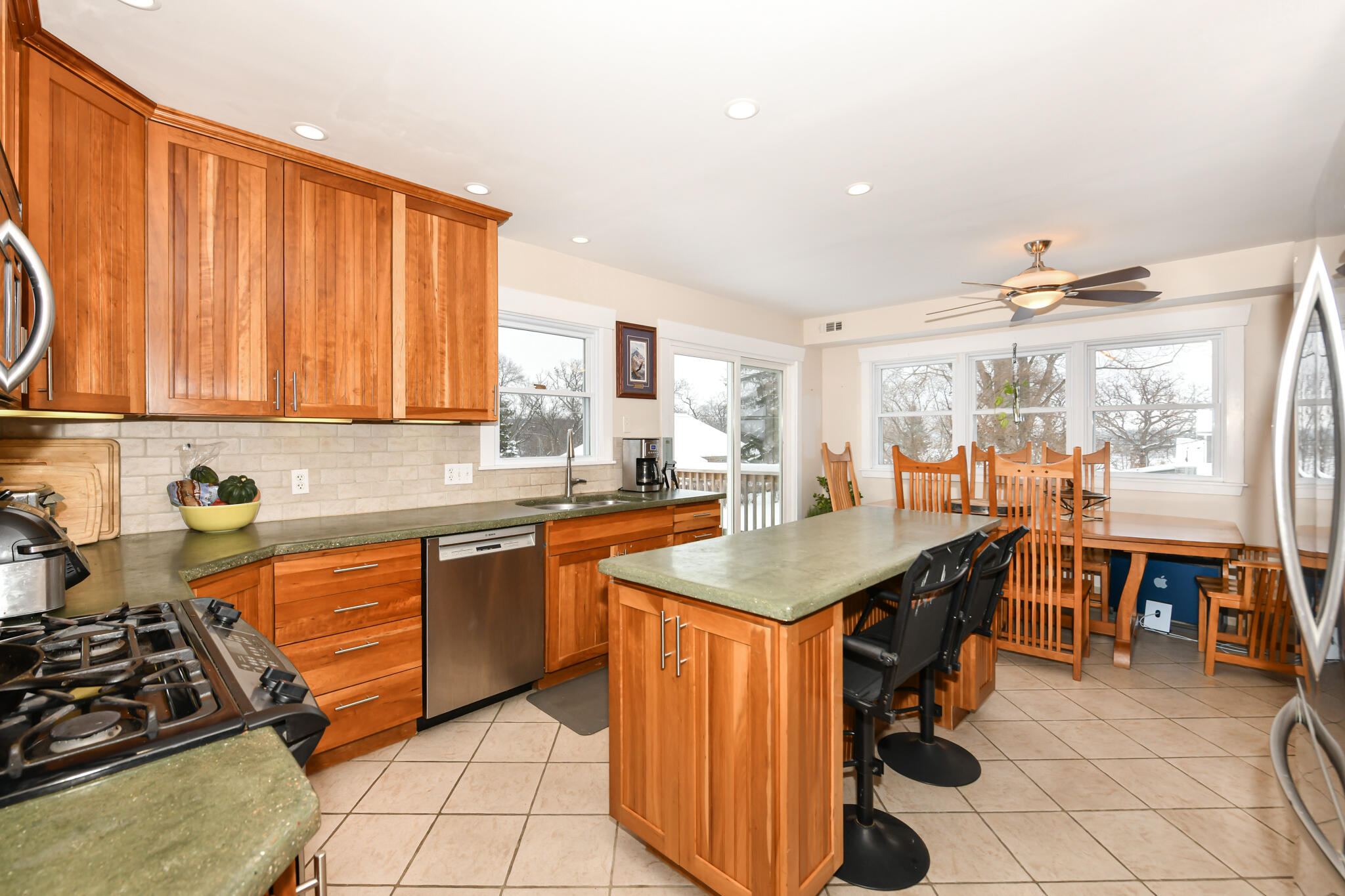 4222 Maple Drive Delavan, WI 53115 - Photo 3 of 44 Heated floors keep you comfortable when preparing meals in the kitchen of your dreams with natural cherry cabinets and custom concrete counters.