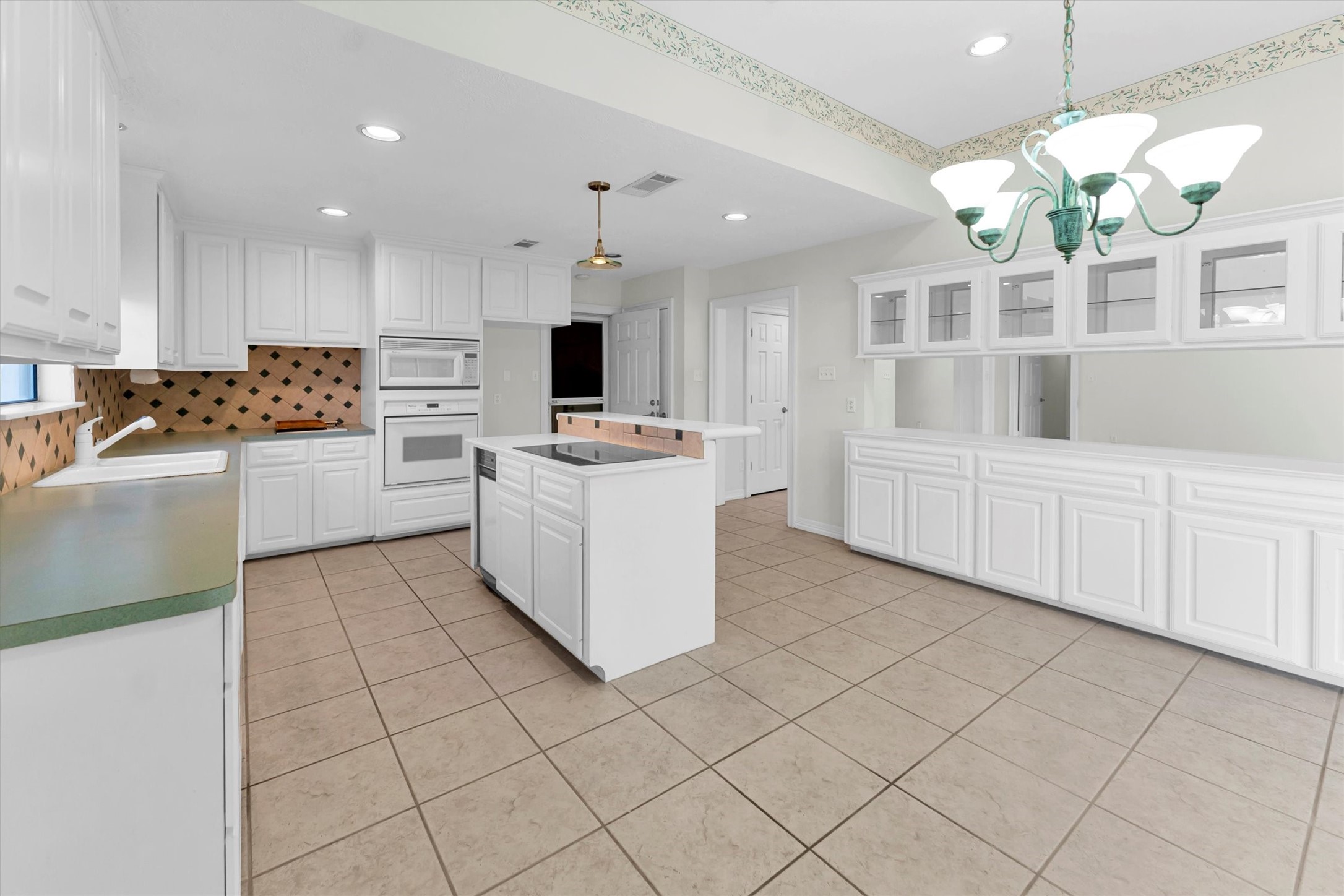 22509 Pebble Beach Way Point Blank, TX 77364 - Photo 19 of 50 a kitchen with cabinets and window