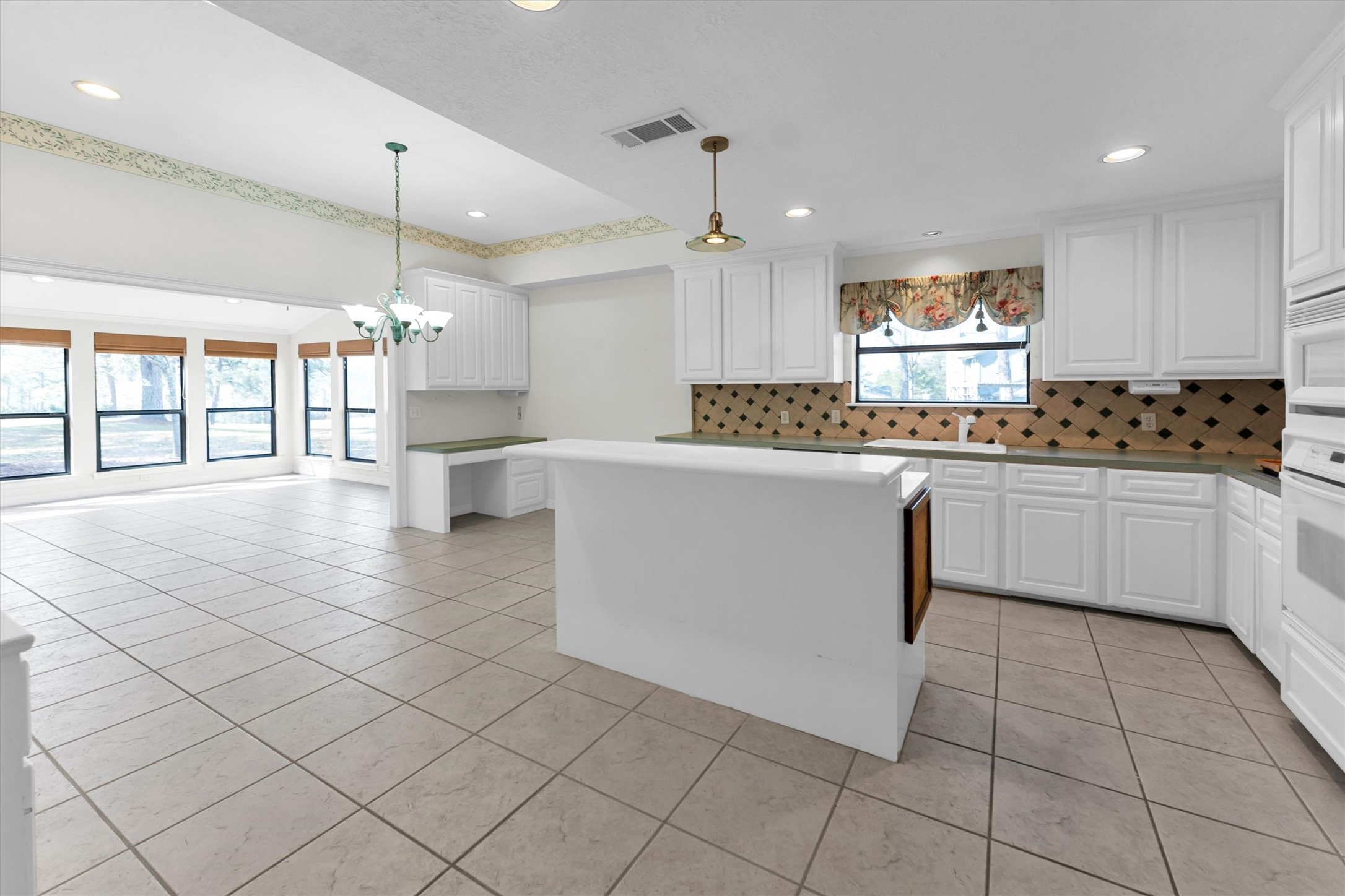 22509 Pebble Beach Way Point Blank, TX 77364 - Photo 26 of 50 a kitchen with stainless steel appliances a sink a stove a microwave a center island and cabinets