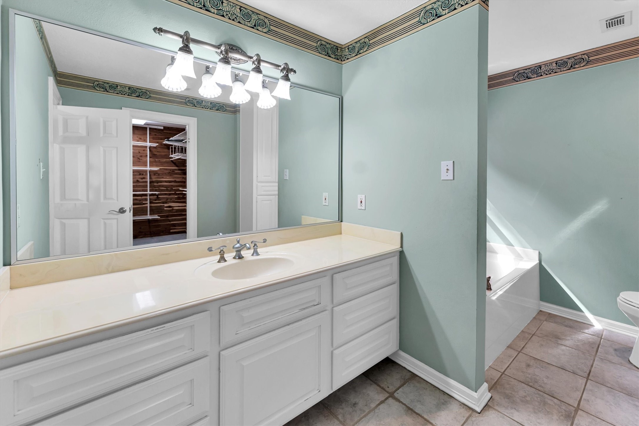 22509 Pebble Beach Way Point Blank, TX 77364 - Photo 30 of 50 a bathroom with a sink vanity and a mirror