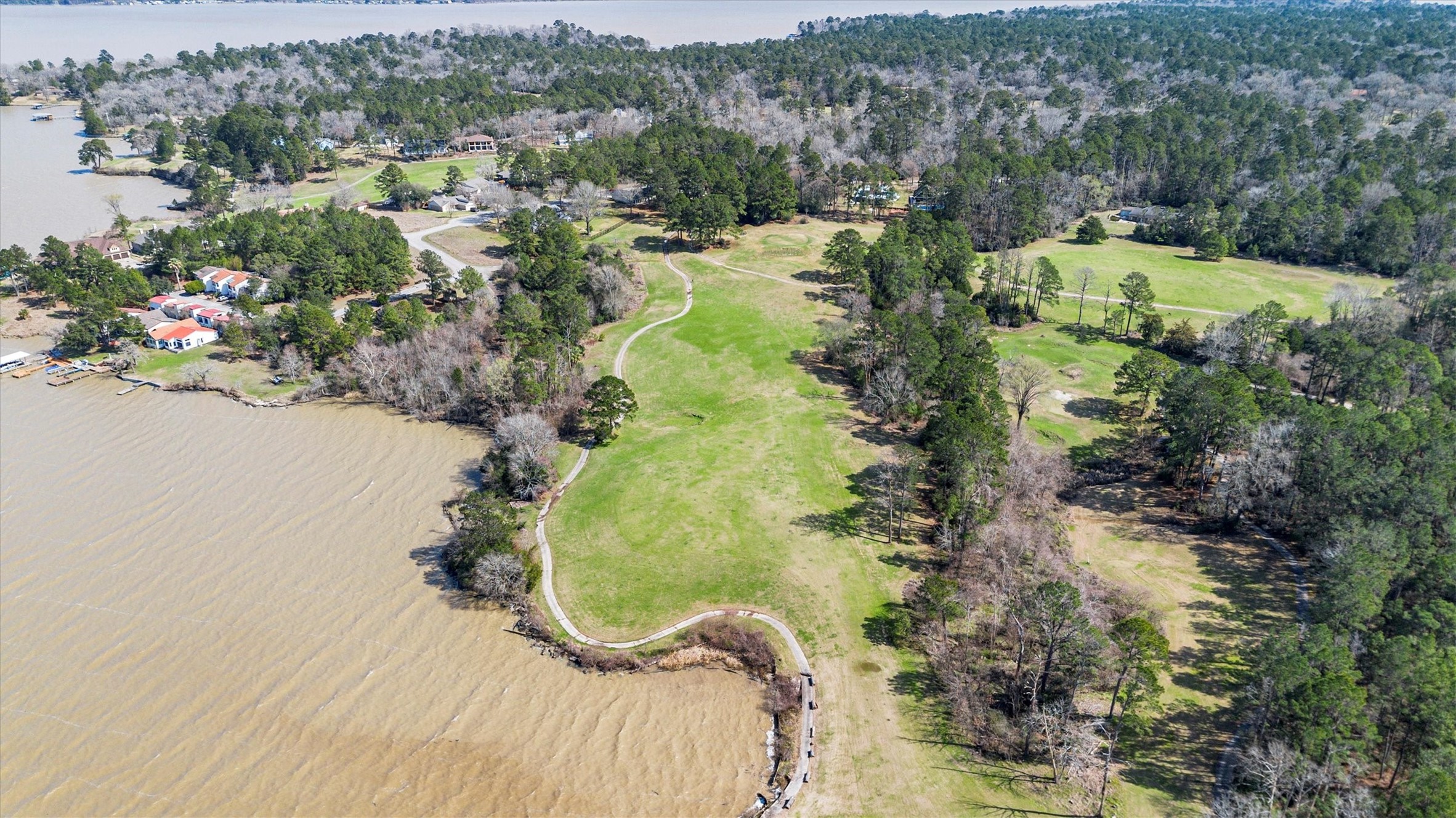 22509 Pebble Beach Way Point Blank, TX 77364 - Photo 41 of 50 an aerial view of a house with a yard and lake view