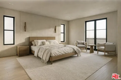 a bedroom with a bed and a couch next to a window