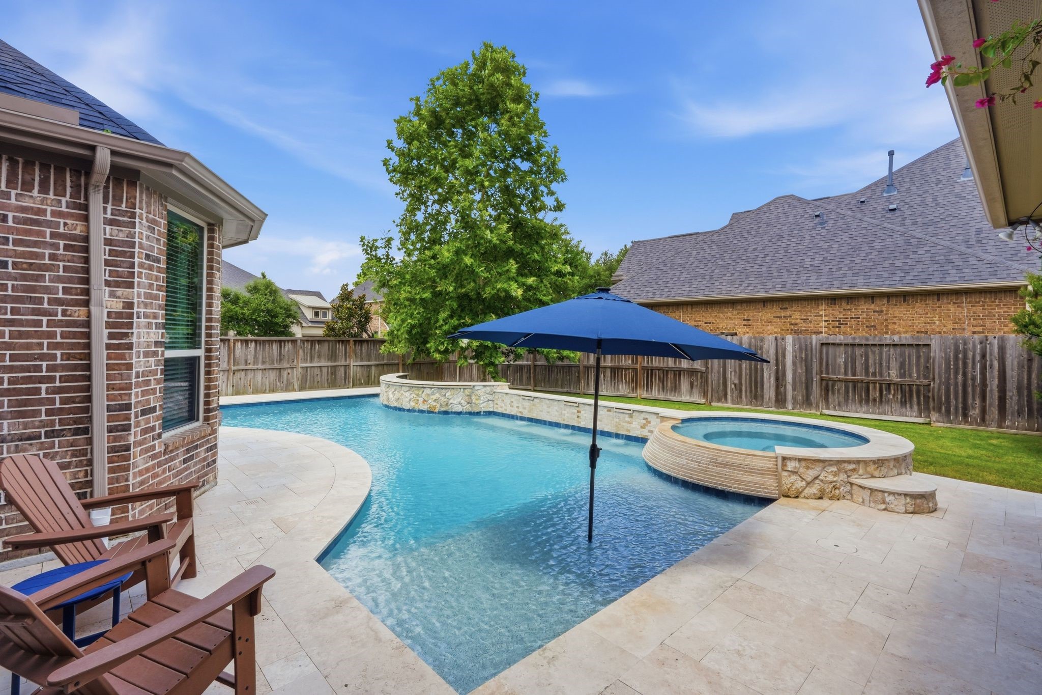 27705 South Slate Hills Lane Spring, TX 77386 - Photo 36 of 45 Custom pool and heated spa wrapped in premium, elegant Travertine tile decking.