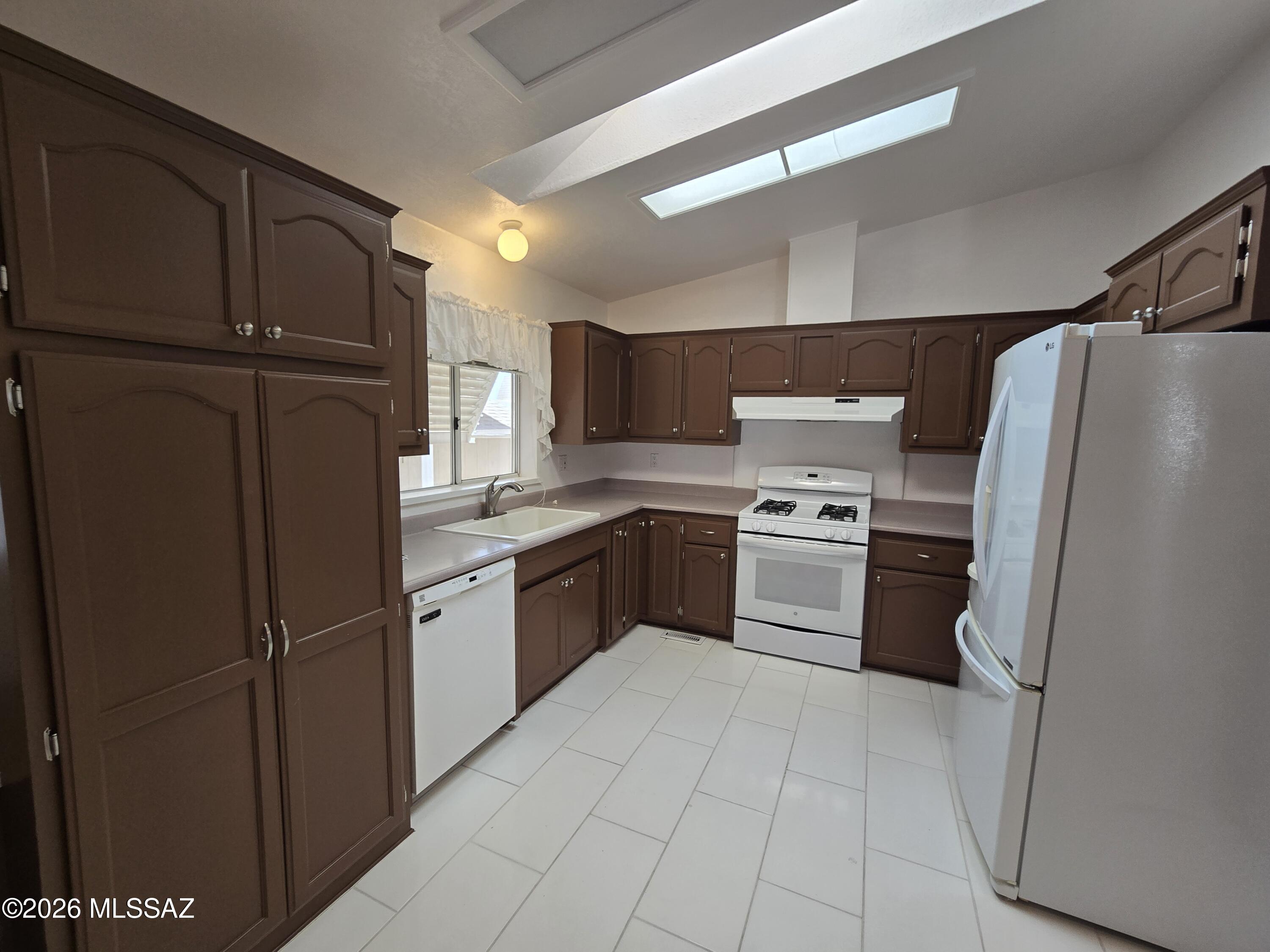 8401 South Kolb Road, Unit 61 Tucson, AZ 85756 - Photo 14 of 23 a kitchen with a refrigerator sink and cabinets