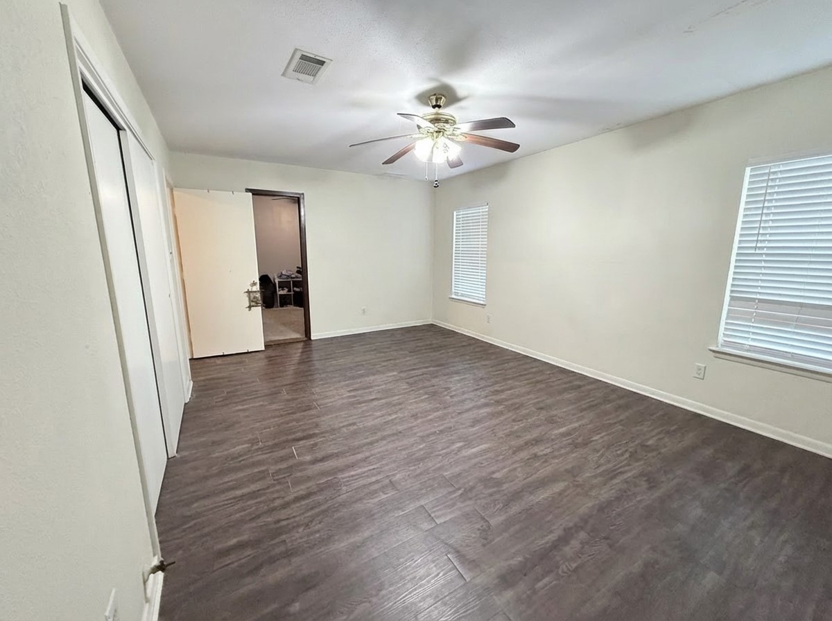 503 Honeysuckle Drive La Marque, TX 77568 - Photo 14 of 24 a view of an empty room with wooden floor and a window