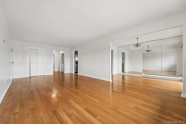 a view of empty room with wooden floor