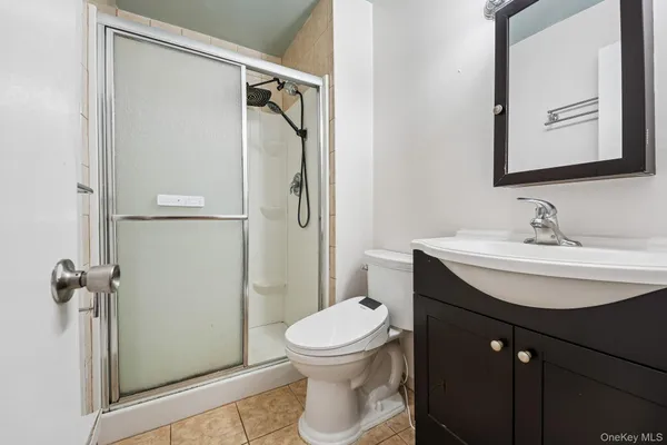 a view of empty room with closet and wooden floor