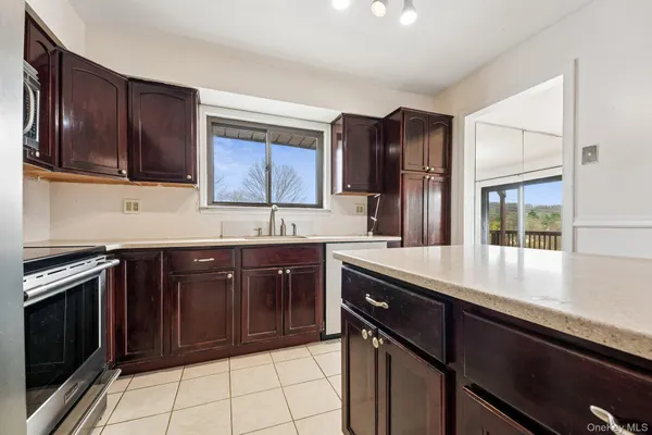 a kitchen with a sink stove and microwave