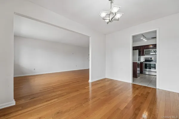a view of a room with wooden floor and window