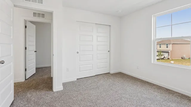 an empty room with a empty space and windows