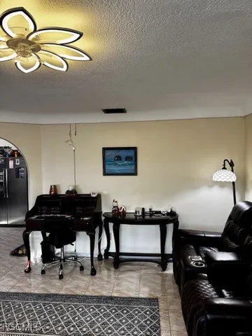 a living room with furniture and a piano