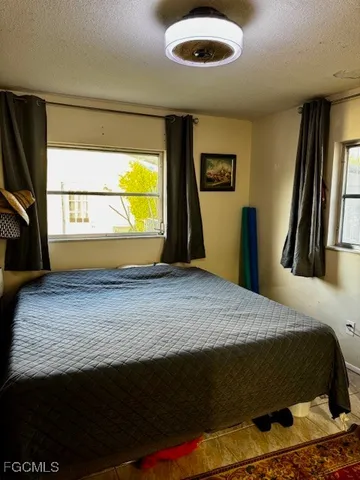 a bedroom with a bed and a large window